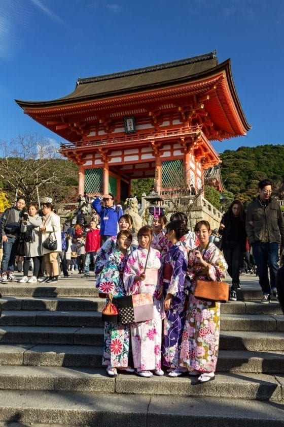 Entrance to Kiyomizy dera temple with girls in traditional attire
