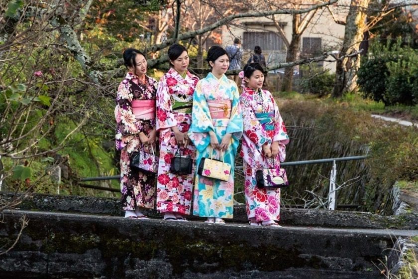 Girls in kimonos taking a picture on the philosopher's path in Kyoto