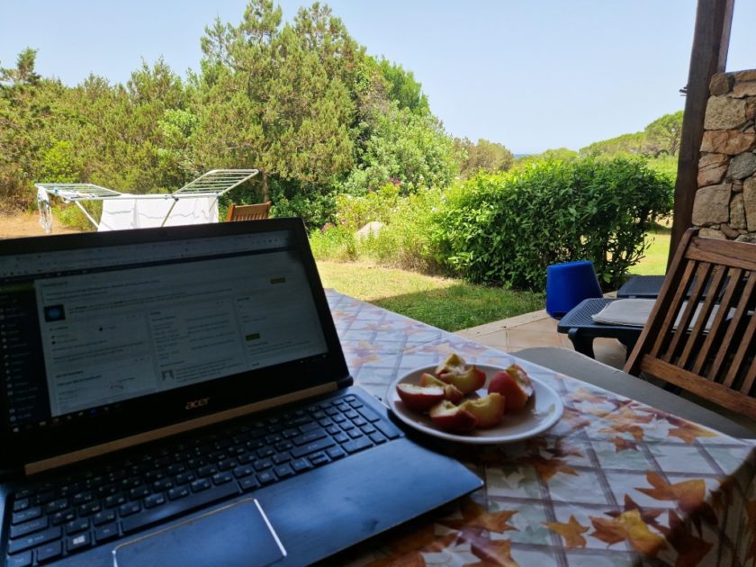 Studying while travelling - 9 tips from a travelling student working in sardinia working on a terrace in a hotel in sardina